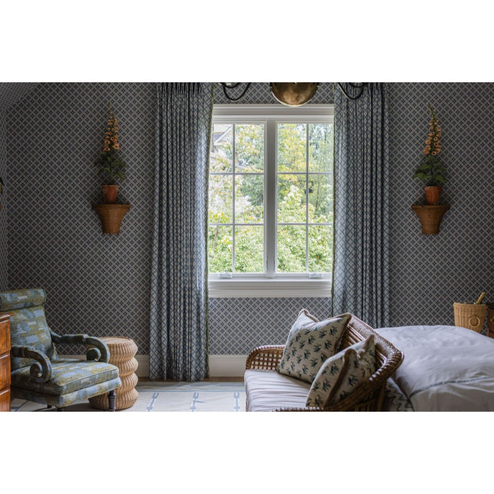 Living room with patterned wallpaper, a window, and decorative elements.