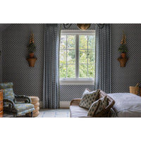 Living room with patterned wallpaper, a window, and decorative elements.