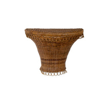 Wicker wall shelf with fringe on a white background