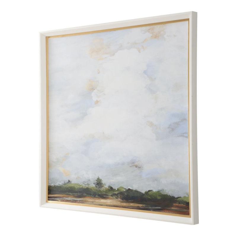 Uttermost's Whispering Cloudscapes Framed Print features a landscape with a cloudy sky and green horizon in a white wood grain frame.