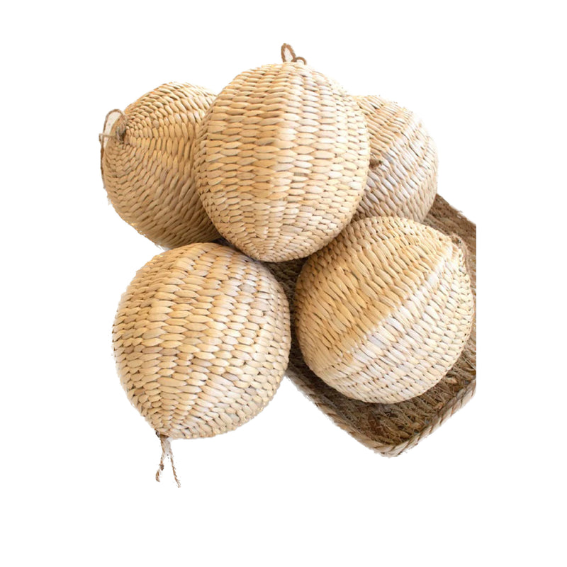 Five baskets with an oval shape, resembling Woven Seagrass Ball Ornaments from Kalalou, stacked together on a white background.