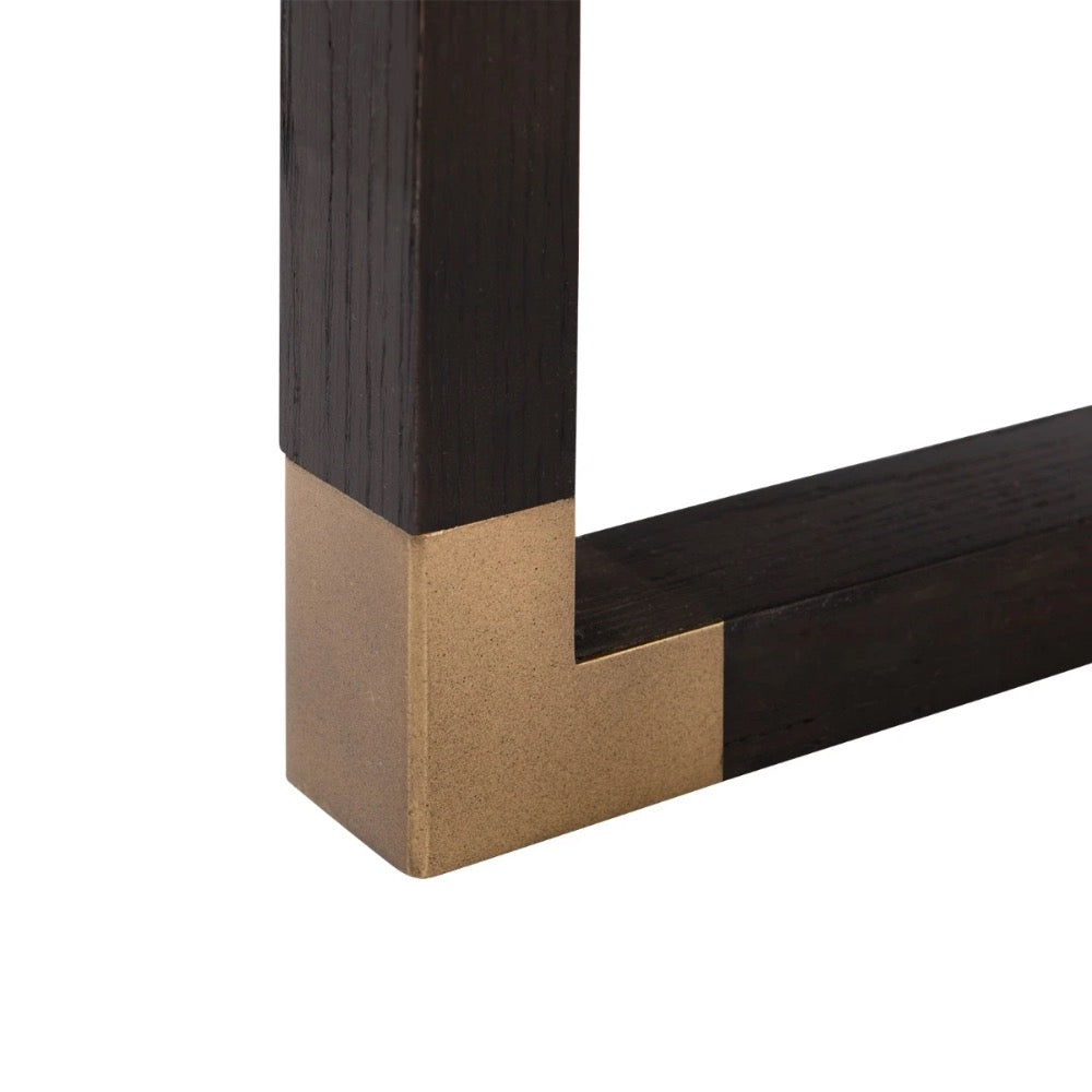 Close-up of a dark wood frame corner with gold accent on a white background