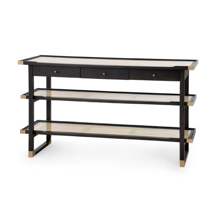 A modern three-tier console table with a black frame, natural woven cane shelves, and three drawers on the top with brass knobs, shown on a white background.