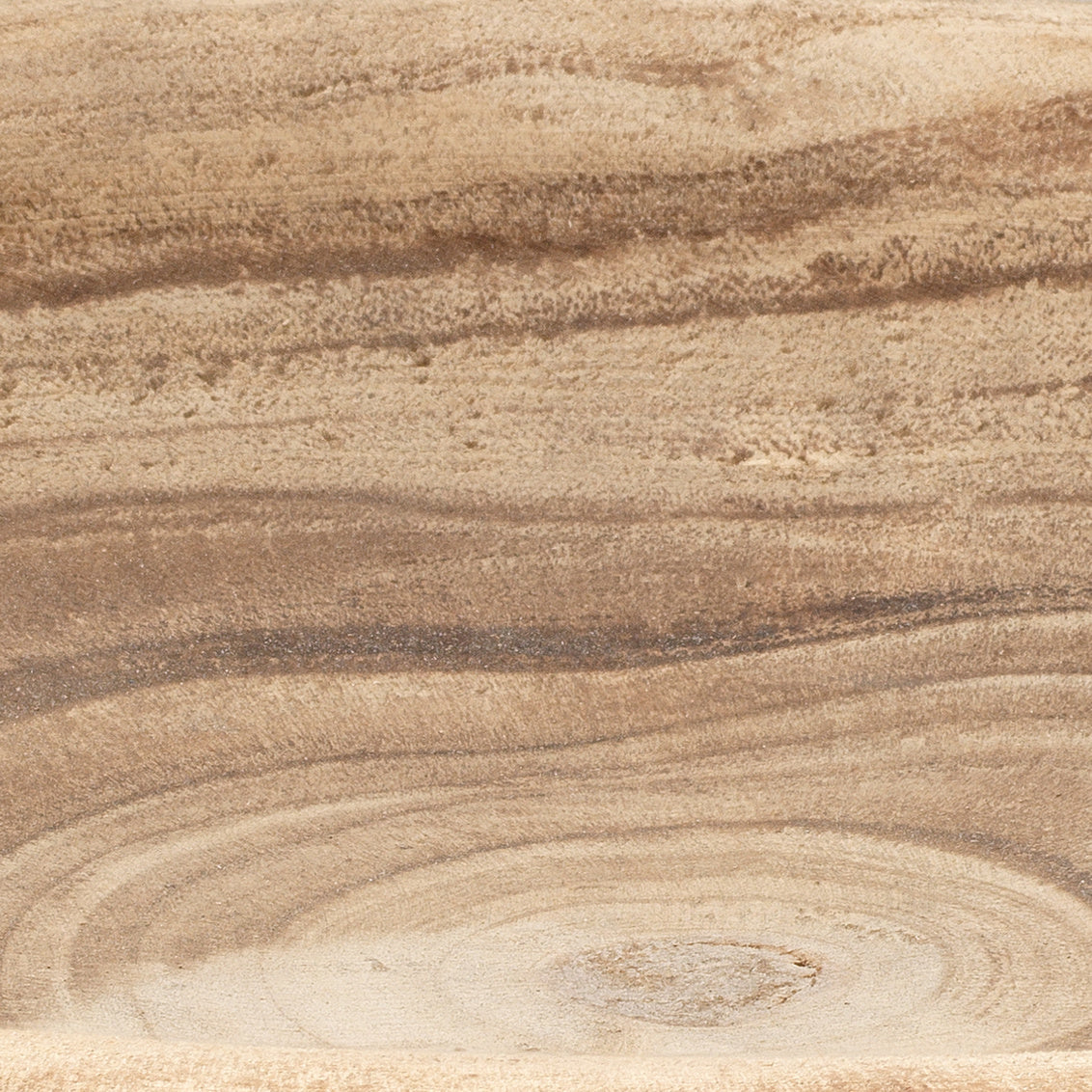 Close-up of a Laurel Small Paulownia Wood Bowl by Jamie Young, highlighting its organic swirling grain patterns.