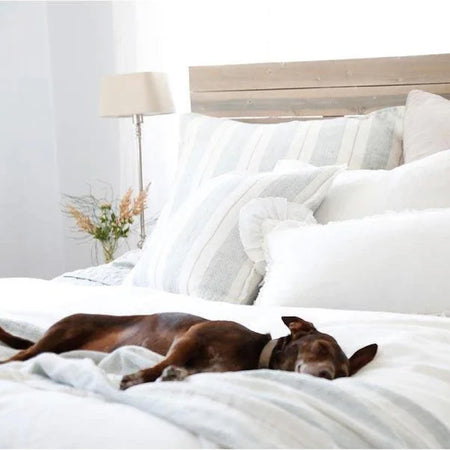 white and stripe bed pillows and white comforter