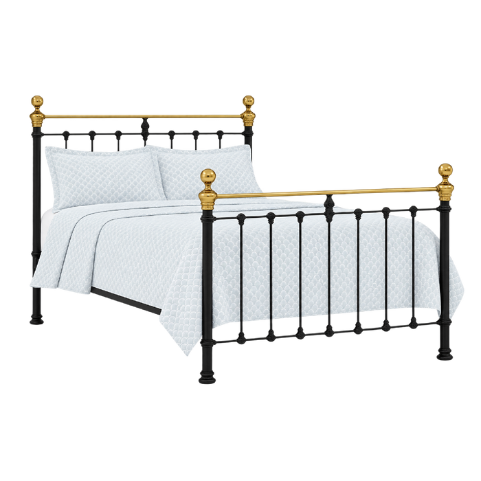 Orchids Lux Home Castile black and brass queen bed with sprung slats, white pillows, and a patterned comforter.