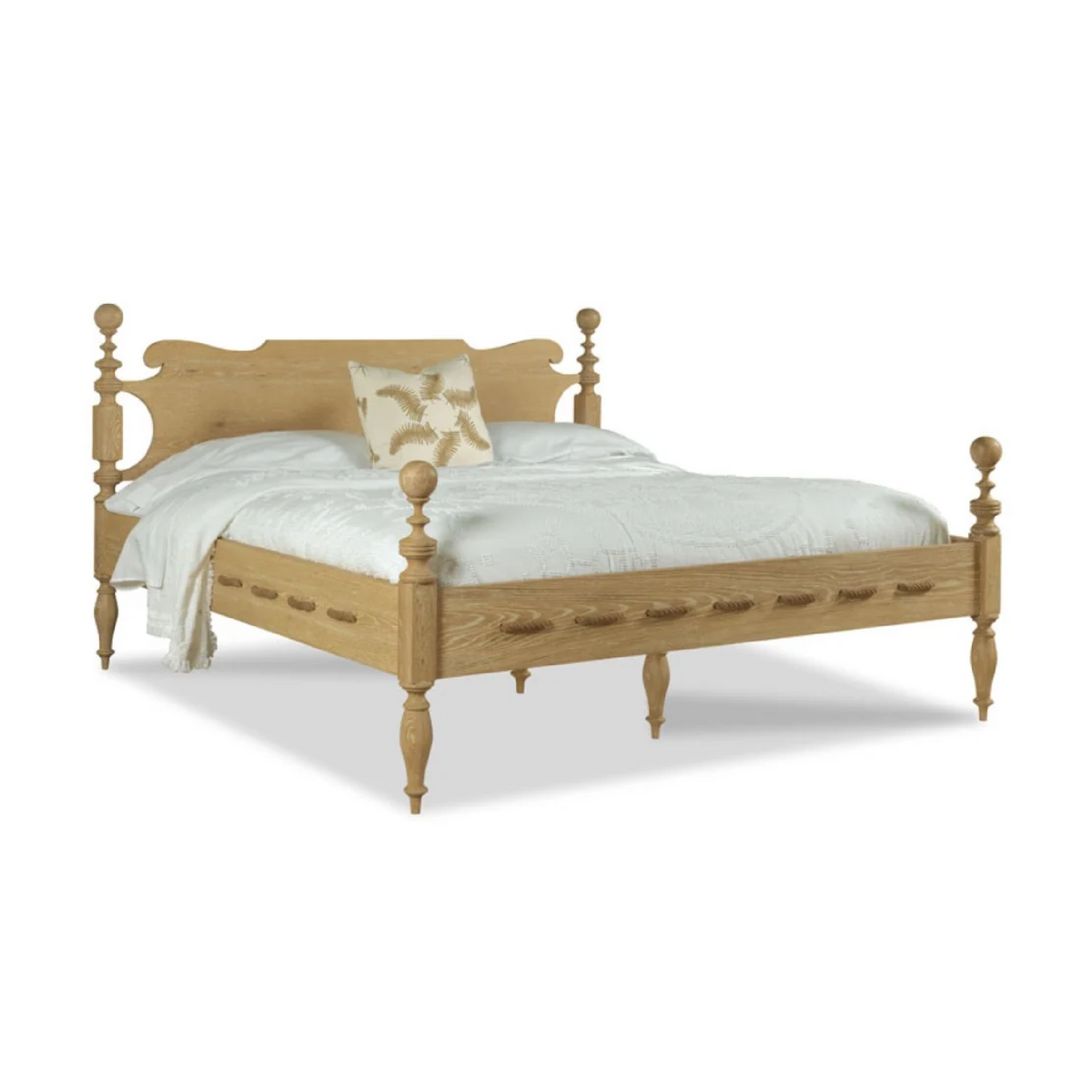 Saltwater Queen Bed Limewash by Woodbridge Furniture with white bedding and a beige floral accent pillow.