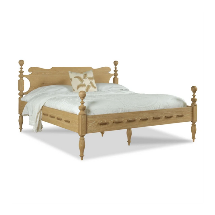 Saltwater Queen Bed Limewash by Woodbridge Furniture with white bedding and a beige floral accent pillow.
