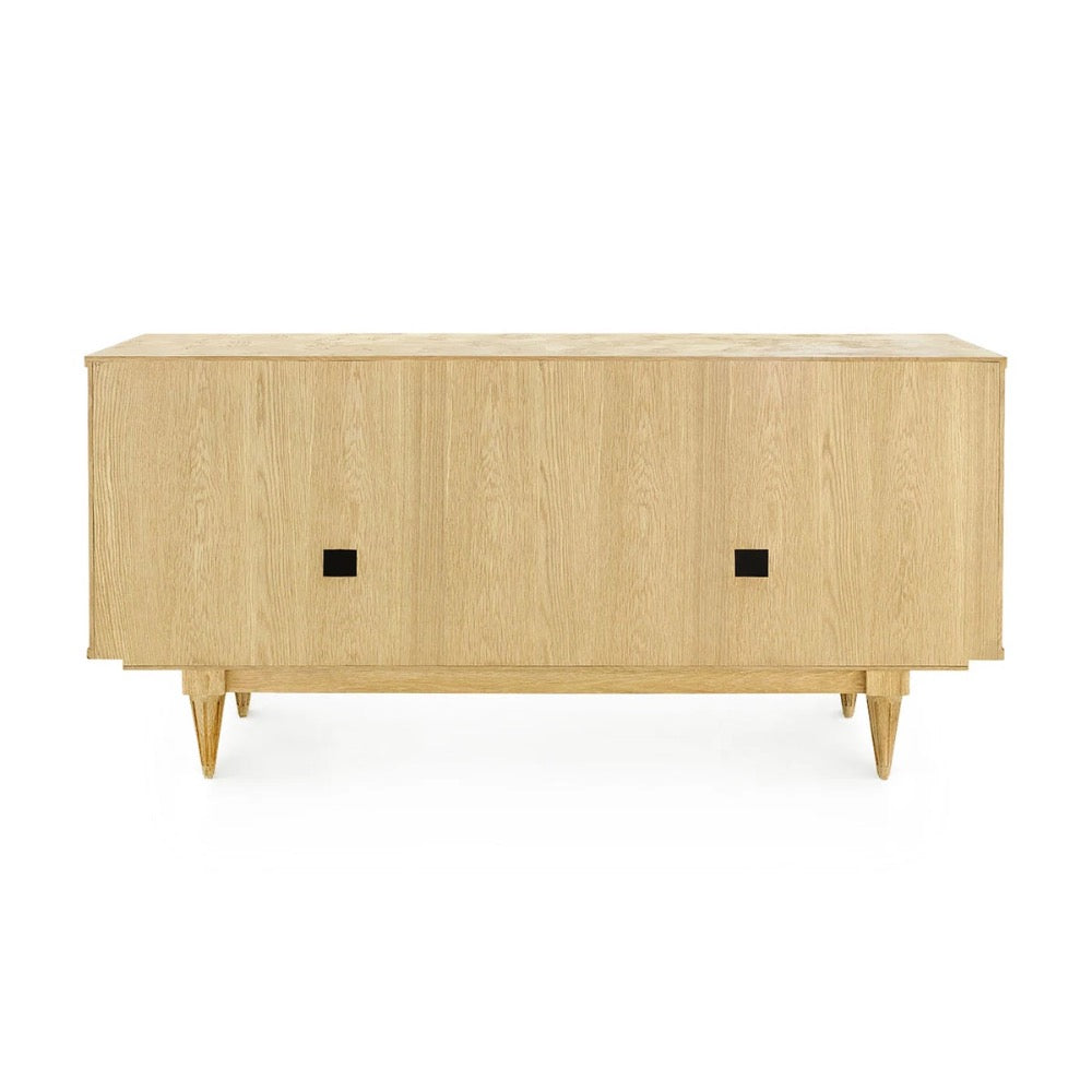 A mid-century modern sideboard or credenza made of light natural oak wood, featuring two doors with small square black pulls and tapered legs, shown against a plain white background.