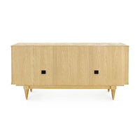 A mid-century modern sideboard or credenza made of light natural oak wood, featuring two doors with small square black pulls and tapered legs, shown against a plain white background.