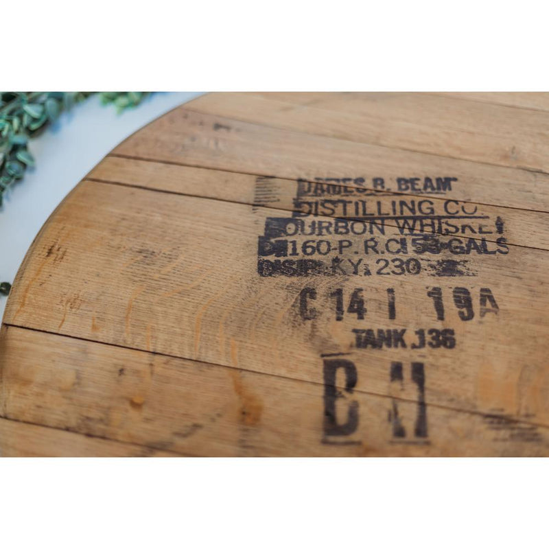 Close-up of a rustic Bourbon Head Lazy Susan Tray by Sono Inspired, showcasing the option for stamped text detailing "James B. Beam Distilling Co." and other capacity information. This piece is perfect as a unique centerpiece crafted from repurposed materials.