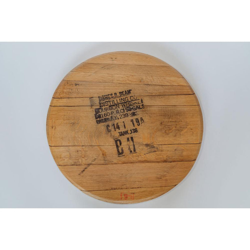 The Bourbon Head Lazy Susan Tray from Sono Inspired is a rustic piece crafted from a wooden bourbon barrel top. It features stamped text and numbers from Jim Beam Distilling Co., all set against a white background, showcasing repurposed materials with timeless charm.