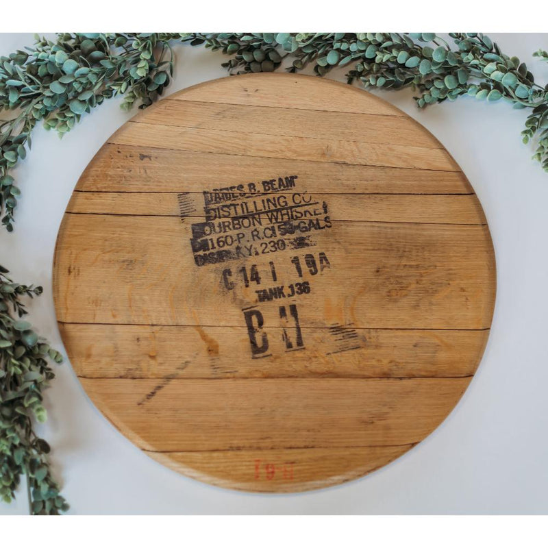 The Bourbon Head Lazy Susan Tray by Sono Inspired features a crafted design from repurposed materials, showcasing stamped text encircled by green leaves.