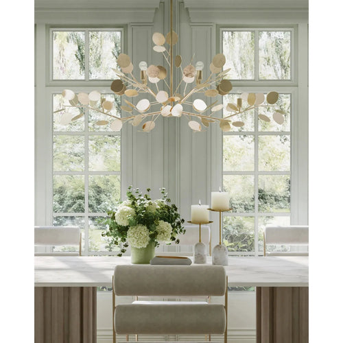 Elegant dining room featuring a Currey & Company Lunaria Silver Oval Chandelier, large window, and flower-adorned table.