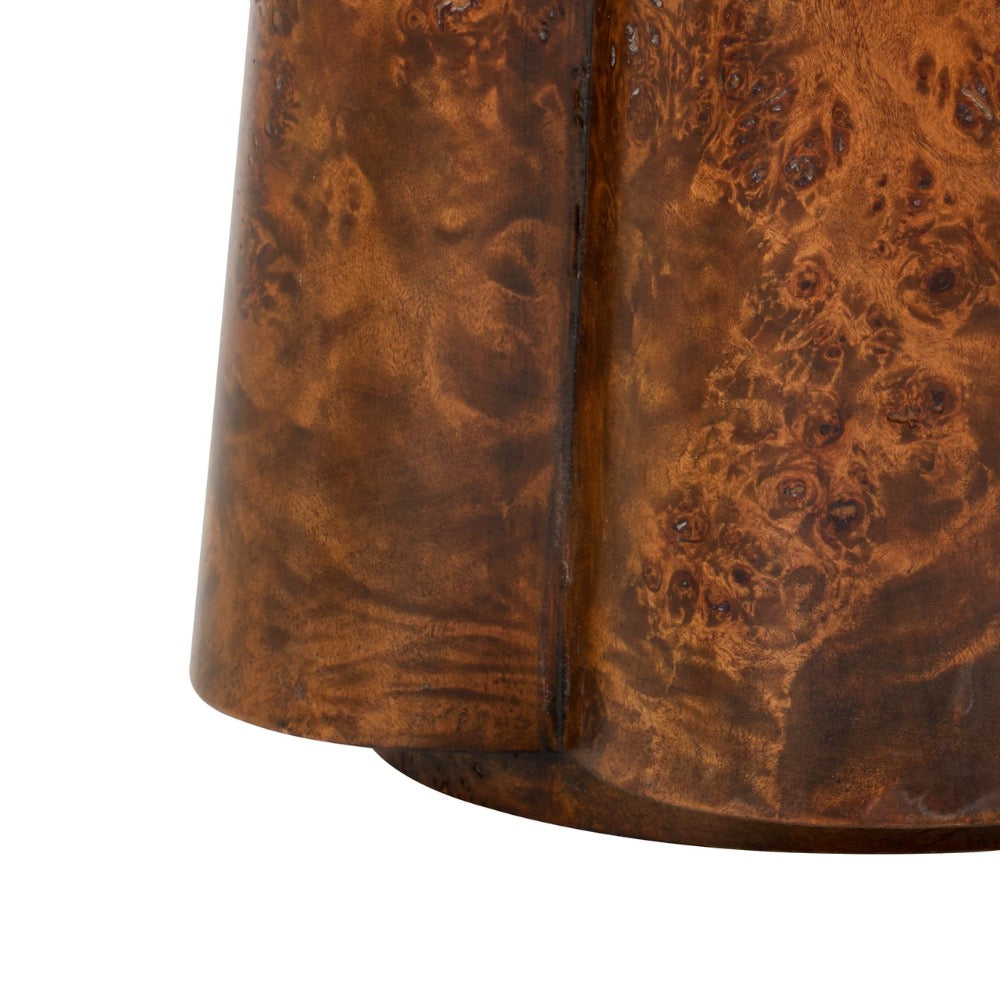 Close-up of a wooden table base with a textured surface on a white background