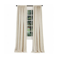 Emdee International Boucle Ivory Cotton Curtain Panel on a black rod frames a window with outdoor greenery views.
