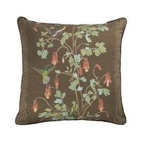 A square decorative throw pillow featuring a detailed botanical and bird pattern on a dark brown background. The design includes green leaves, hanging dusty pink flowers, and two hummingbirds in green and blue.
