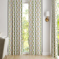 Laura Park Designs Dogwood Curtain Panels in white and green frame the window, highlighting the outdoor greenery.