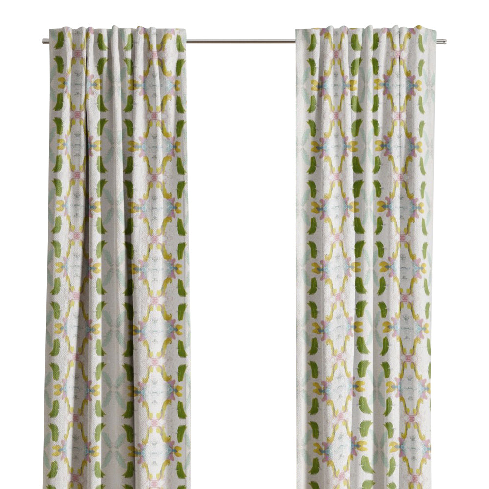 Laura Park Designs Dogwood Curtain Panels in white and green frame the window, highlighting the outdoor greenery.