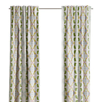 Laura Park Designs Dogwood Curtain Panels in white and green frame the window, highlighting the outdoor greenery.