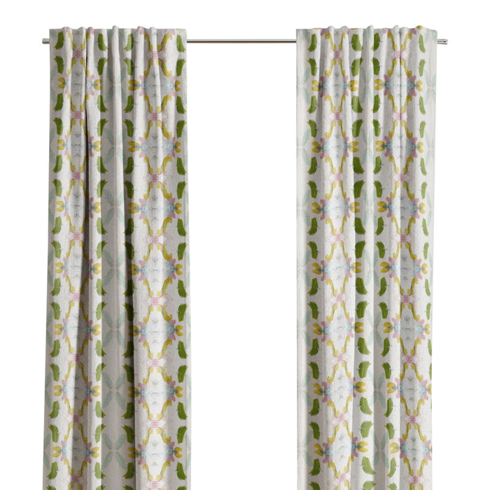 Laura Park Designs Dogwood Curtain Panels in white and green frame the window, highlighting the outdoor greenery.