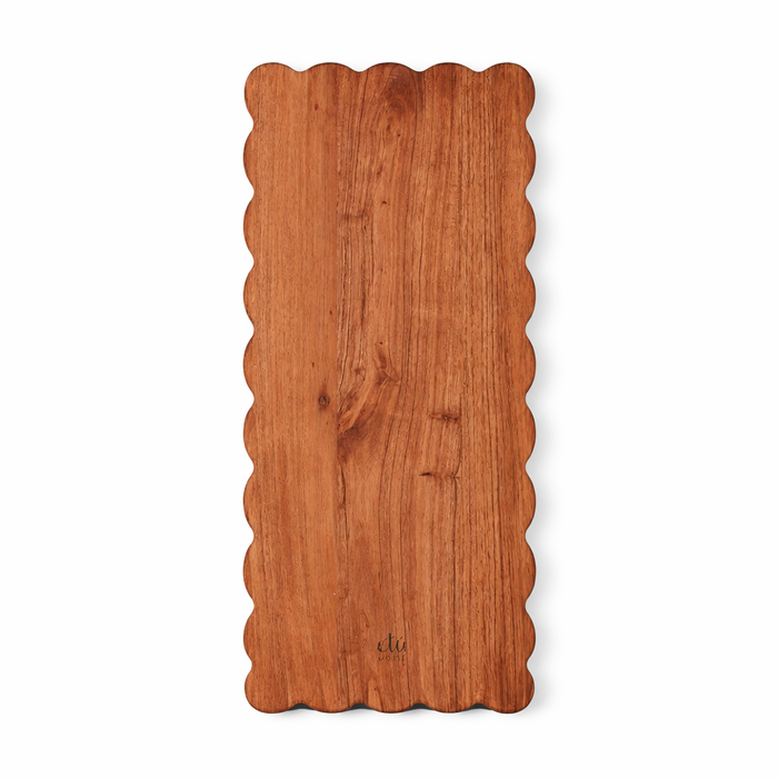 Wooden cutting board with scalloped edge on a white background