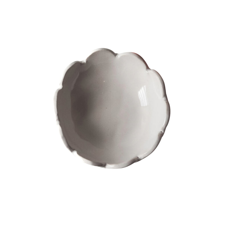 The Scalloped Bloom Nut Bowl by Handmade Studio, a white ceramic bowl with scalloped edges, viewed from above and isolated on a white background.