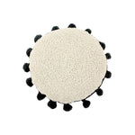 Circle Black Tassel Cushion by Lorena Canals, textured beige with black pom-poms, viewed from above, washable.