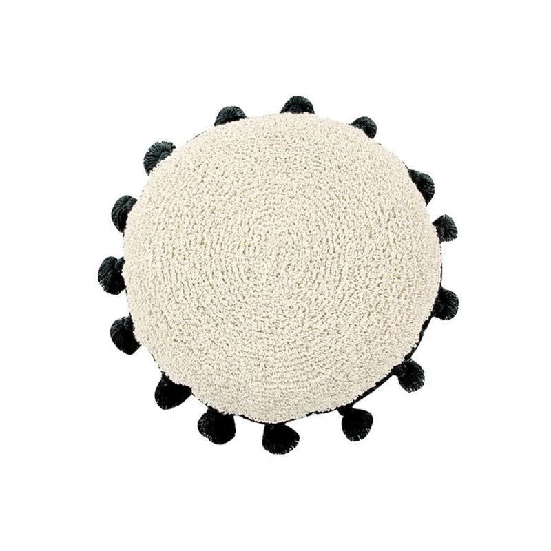 Circle Black Tassel Cushion by Lorena Canals, textured beige with black pom-poms, viewed from above, washable.