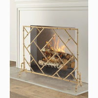 Gold fireplace screen with flames and logs inside a fireplace.