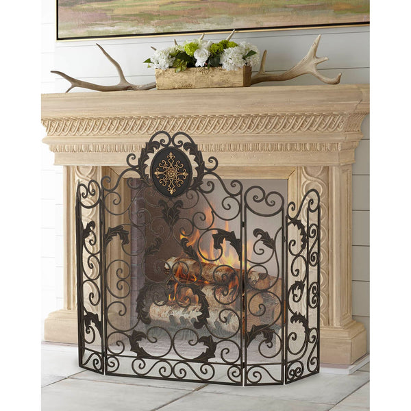 The Dr. Livingstone, I Presume Burnished Gold Fireplace Screen with monogram or Fleur de Lis accents in front of a fire.