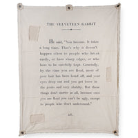 Text from 'The Velveteen Rabbit' on a beige fabric background