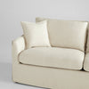 cream slipcovered small 2 cushion sofa