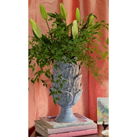 periwinkle blue vase overlapping leaves