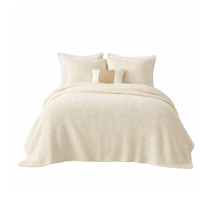 Ivory Mandalay Coverlet by India's Heritage, 100% cotton, with two cushions on a cream bed against a white background.