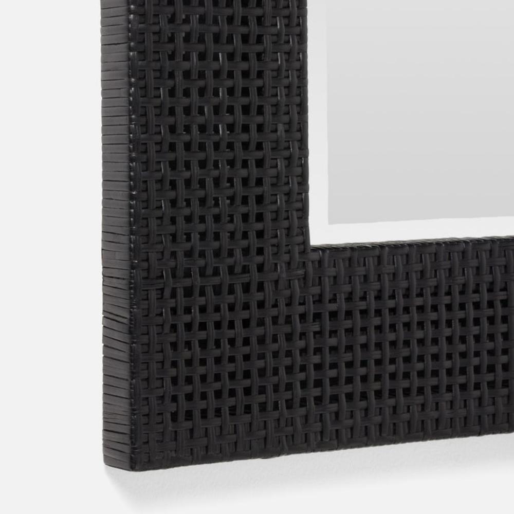 Close-up of a black woven chair frame on a white background