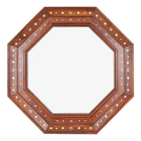 Octagonal wooden mirror with decorative inlay on a white background