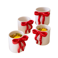 Four Kalalou Ceramic Bow Coffee Mugs (set of 4), two filled with soup, garnished with herbs and yellow toppings.