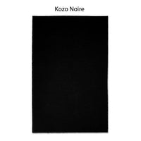 A black rectangular rug featuring the elegant "Kozo Noire" design, inspired by the sophisticated aesthetic of Japanese mulberry paper.