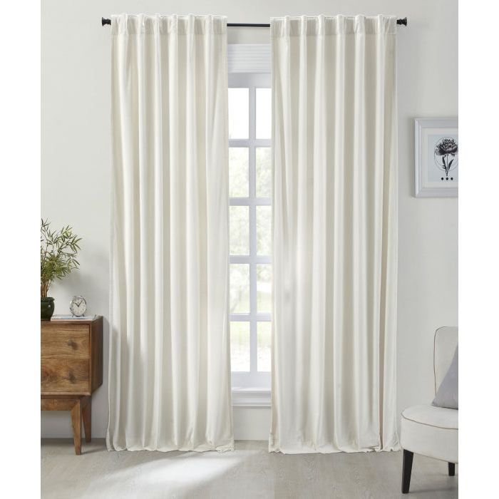 The Stella Ivory Cotton Velvet Curtain Panel by India's Heritage hangs in a bright, modern living room window.