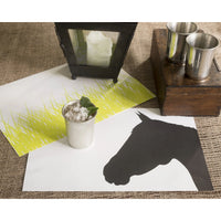 A metal cup with a drink sits on a Plat du Jour Spring Grass Paper Placemat Pad, adding charm to the table.