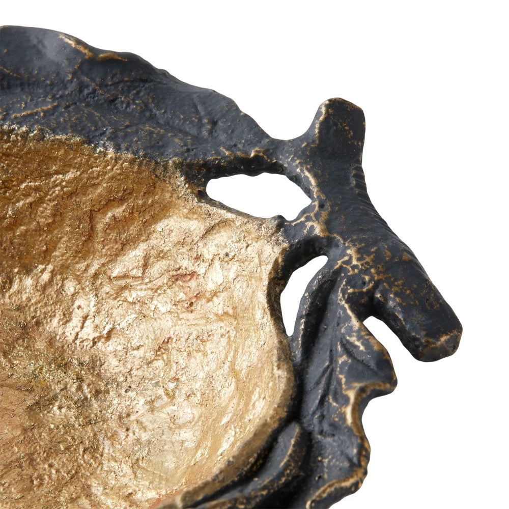 Decorative gold and bronze pomegranate bowl close up on a white background