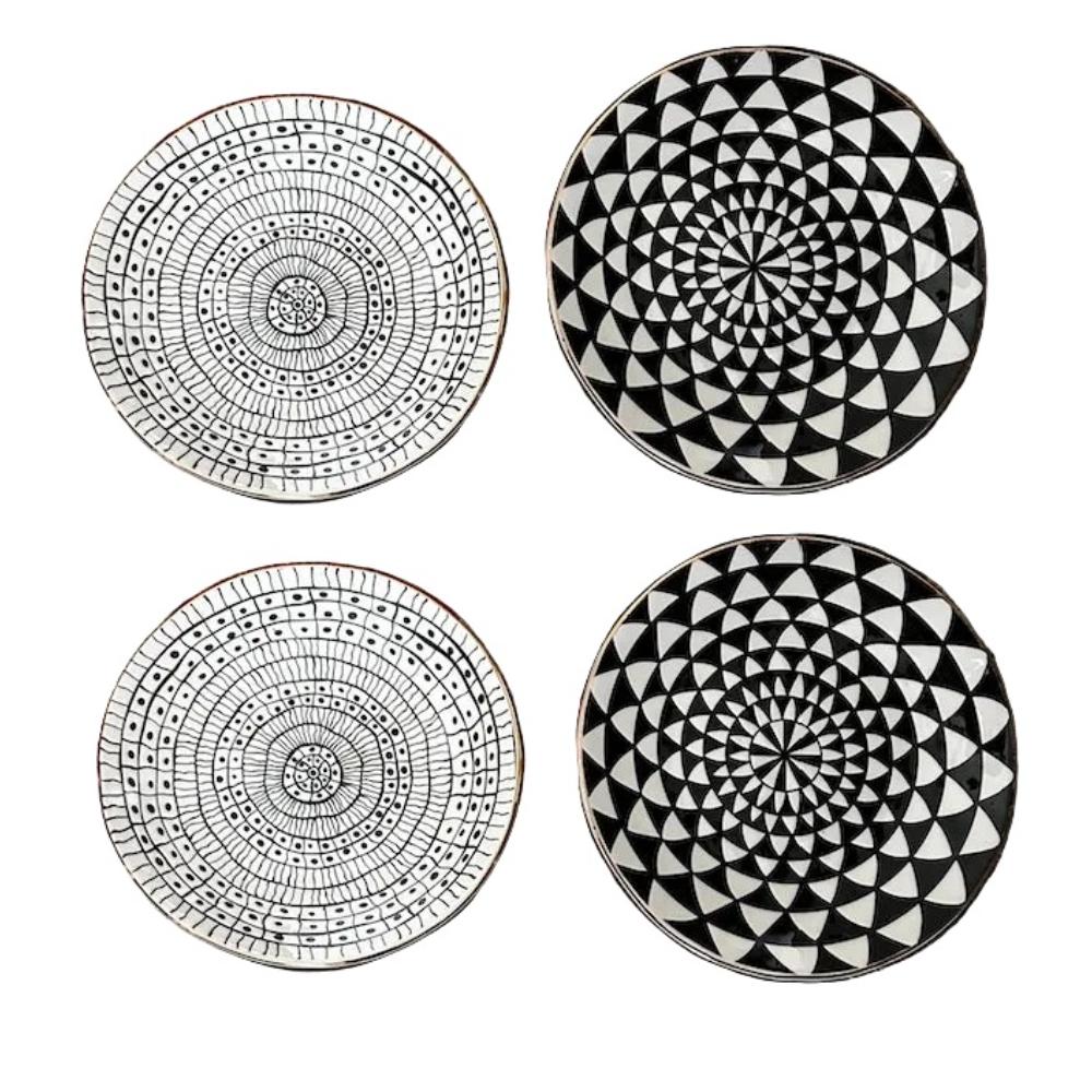Four black and white patterned coasters on a white background