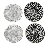 Four black and white patterned coasters on a white background