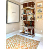 Vinyl Floorcloth in room with chrome bookcase and artwork