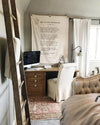 Home office with wooden desk, computer, and decorative elements.
