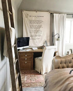 Home office with wooden desk, computer, and decorative elements.