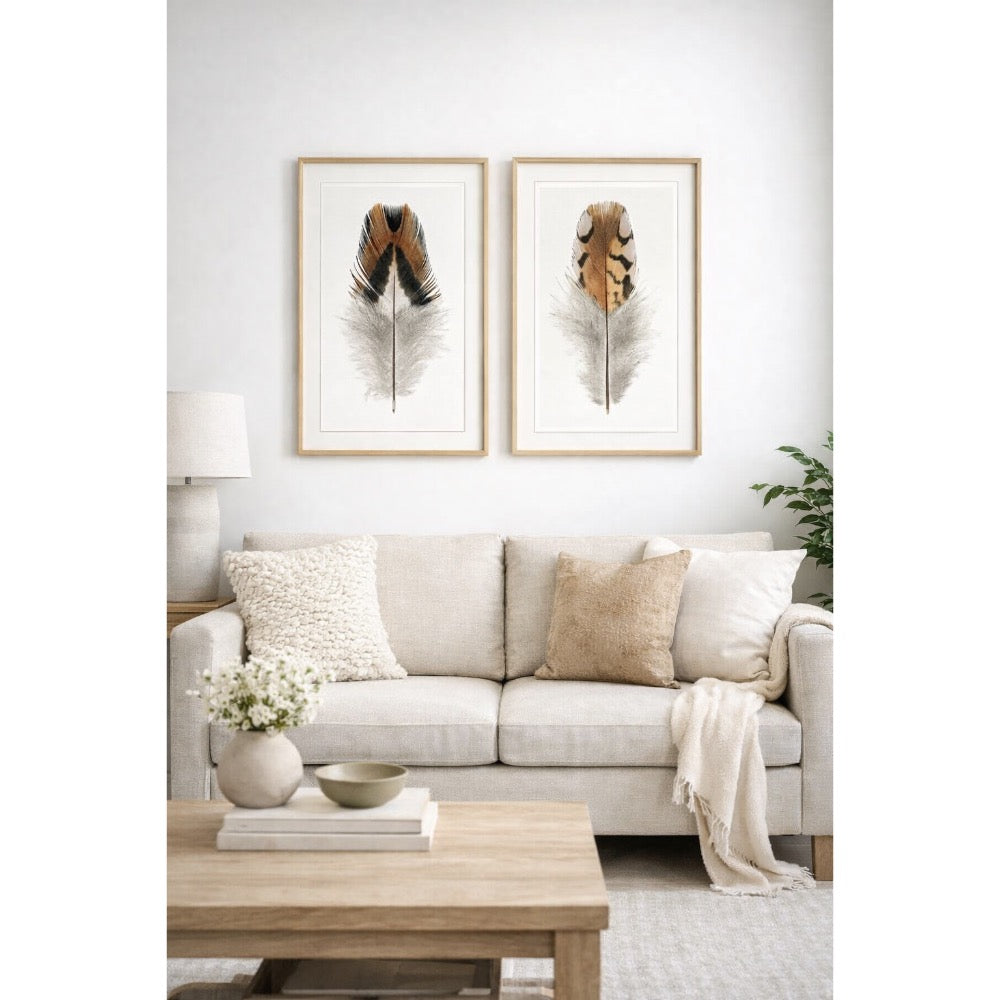 Living room with a beige sofa, wooden coffee table, and framed feather art on the wall.