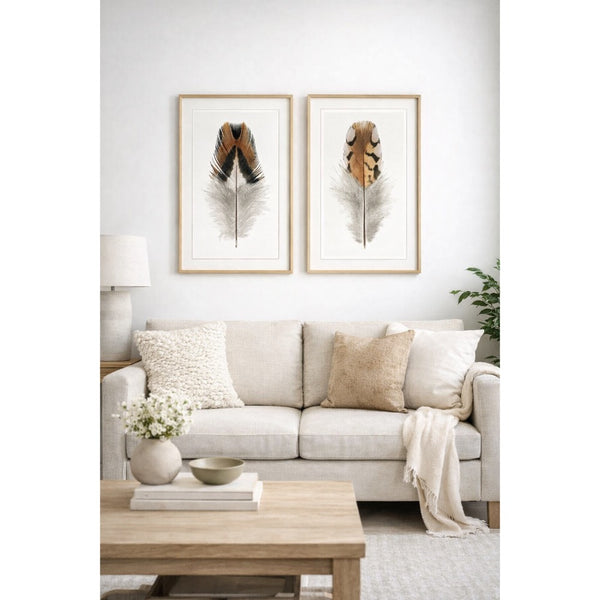 Living room with a beige sofa, wooden coffee table, and framed feather art on the wall.
