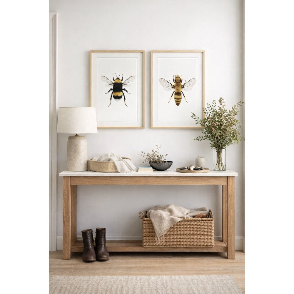 Nest living room with a wooden bench, lamp, and framed bee art on the wall.